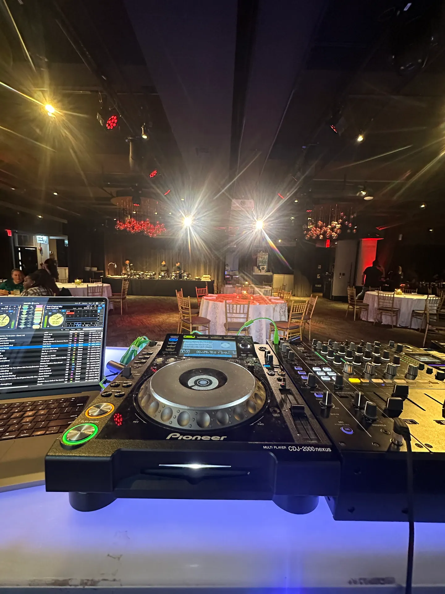 View from the DJ booth across a seated dinner before guests arrive