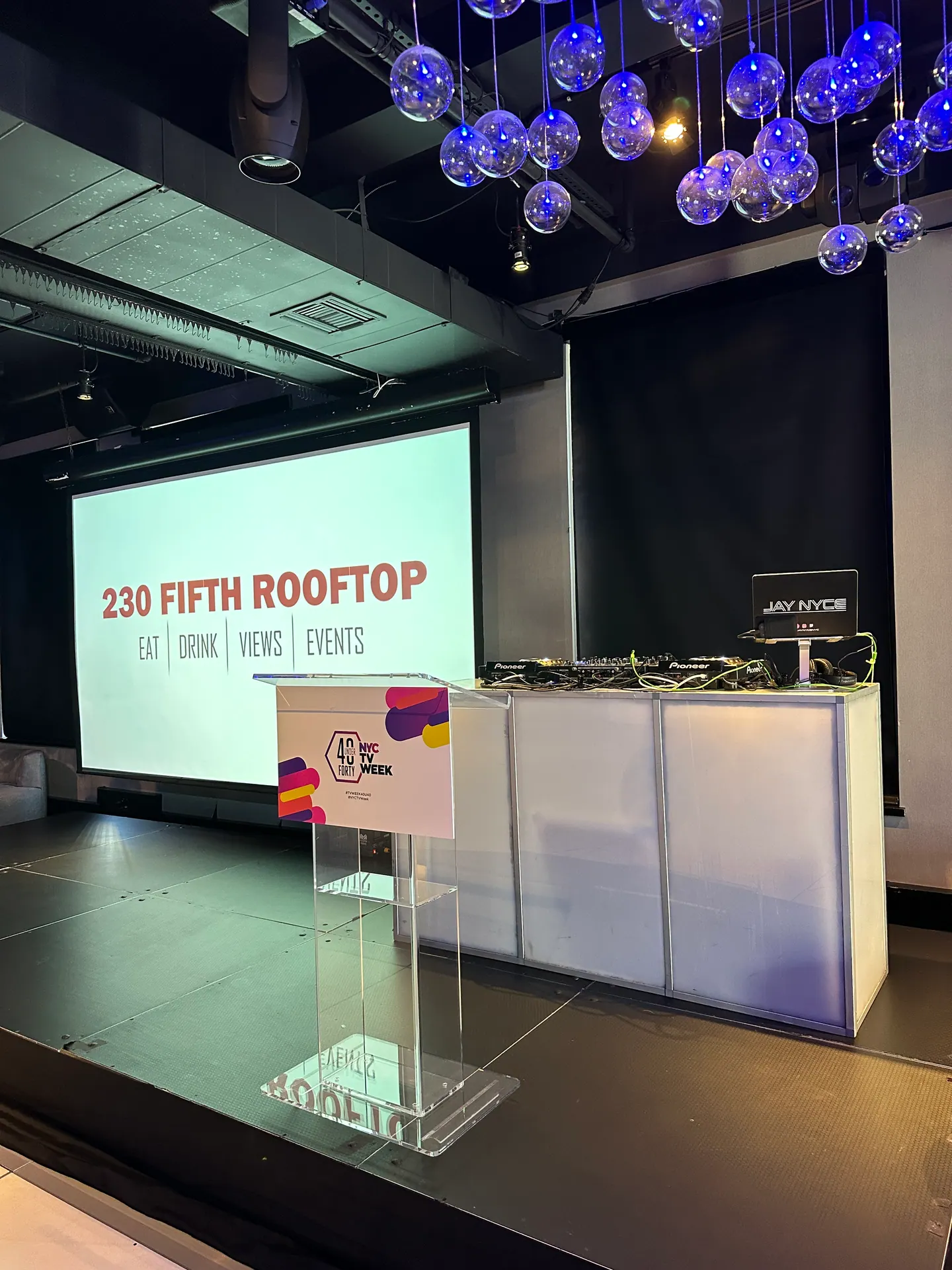 Podium and screen at 230 Fifth Rooftop in Manhattan before a program