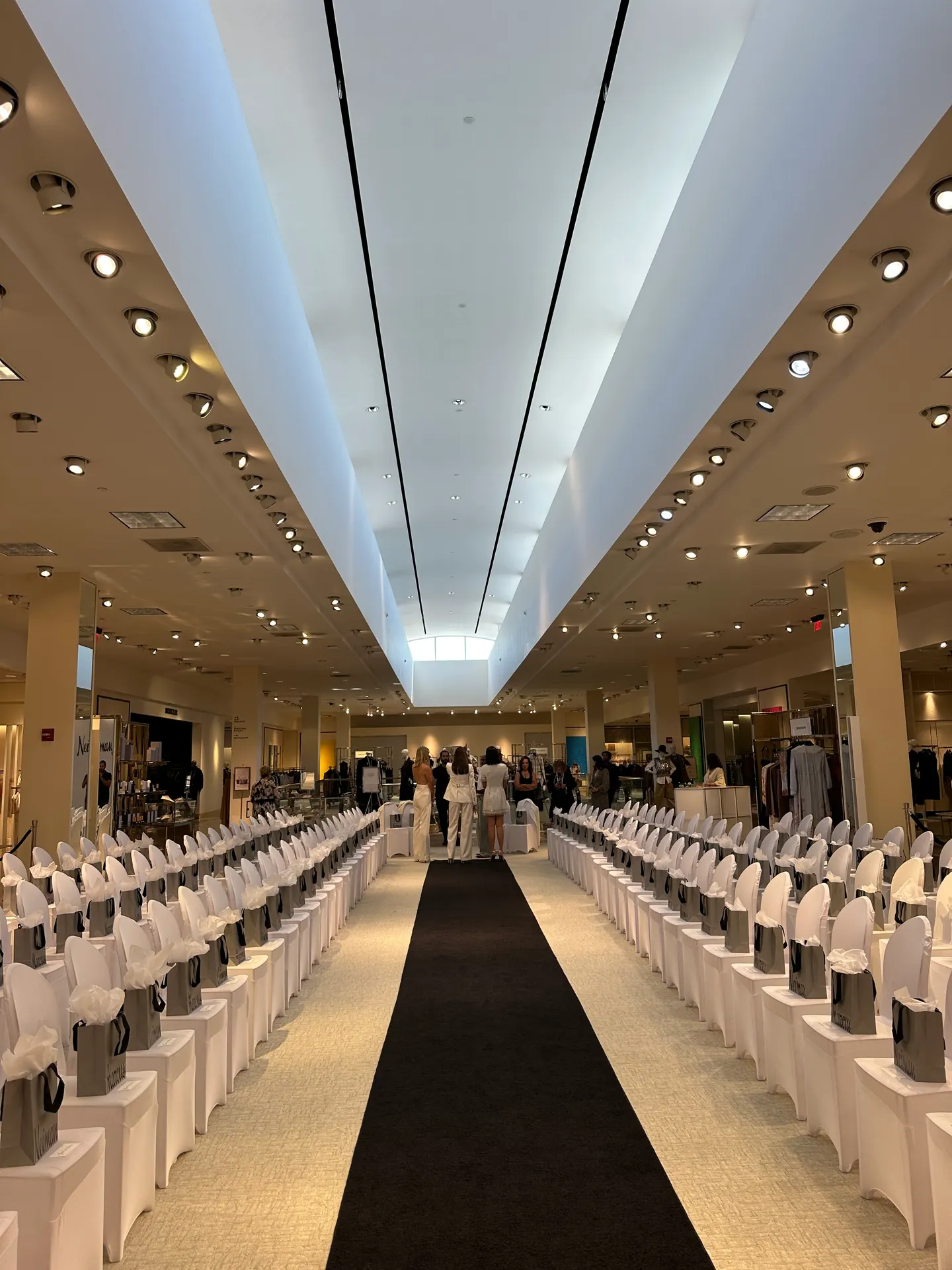 Corporate fashion show with a runway and seated audience, DJ set played to the walk
